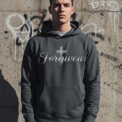 Person wearing a hoodie with 'Forgiven' text against a graffiti-covered wall.