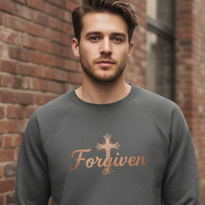 Man wearing a gray sweatshirt with 'Forgiven' text and cross symbol against a brick wall.