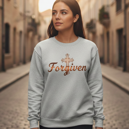 Woman wearing a gray sweatshirt with 'Forgiven' and a cross on a street.