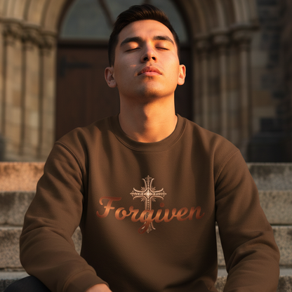 Man wearing a brown sweatshirt with 'Forgiven' printed on it, sitting on steps in front of a stone building.
